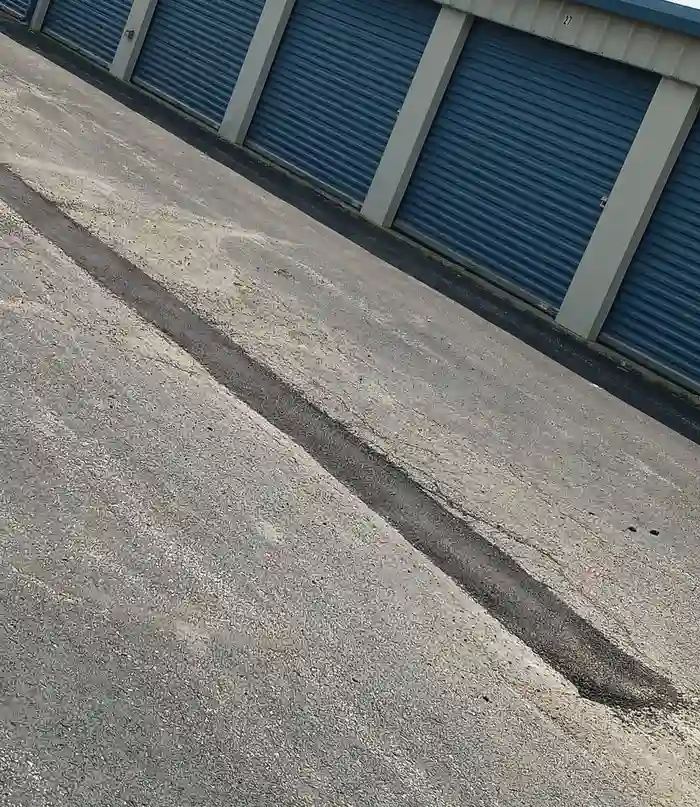Asphalt crew worker spraying sealant